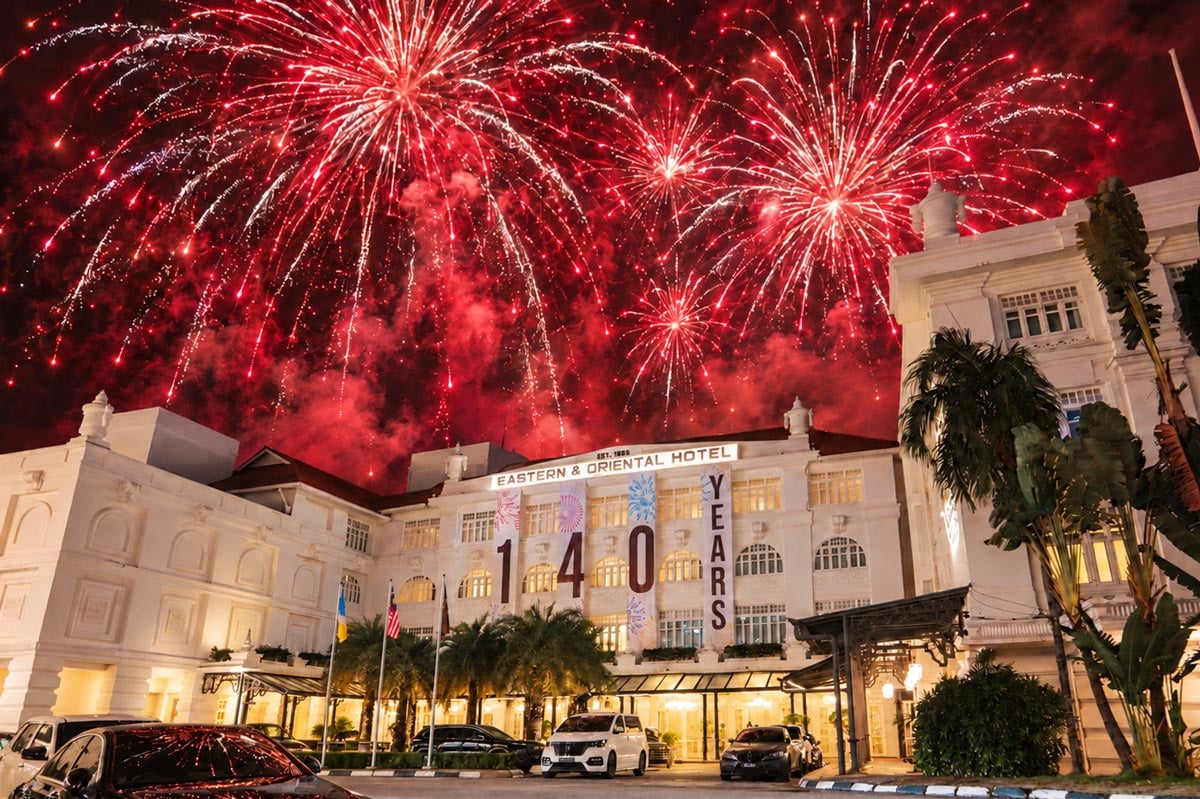 Eastern & Oriental Hotel heritage facade illuminated by grand fireworks celebrating its 140th anniversary in Penang