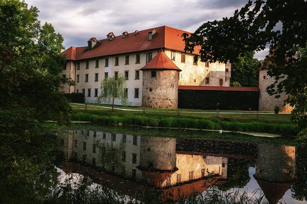 Otočec Castle reflected in the Krka River in Slovenia